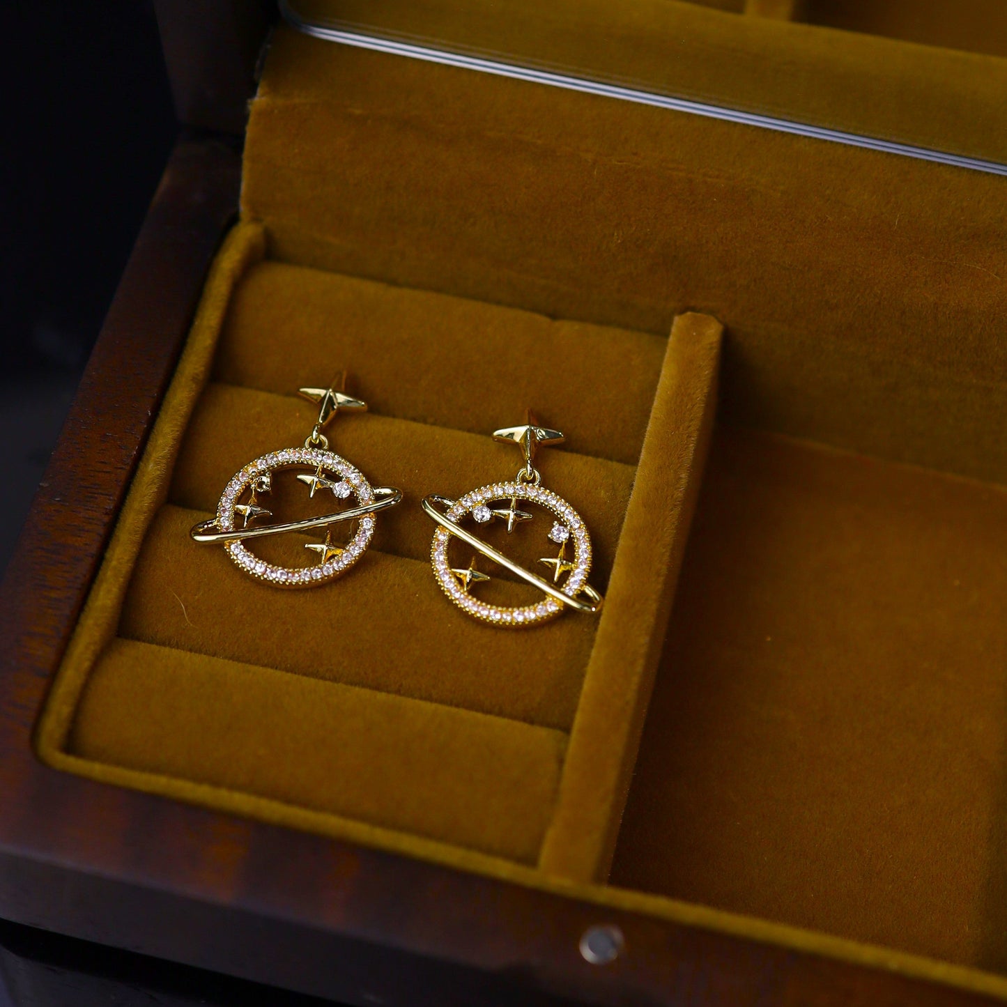 Gold-plated cosmic orbit earrings with cubic zirconia and star details