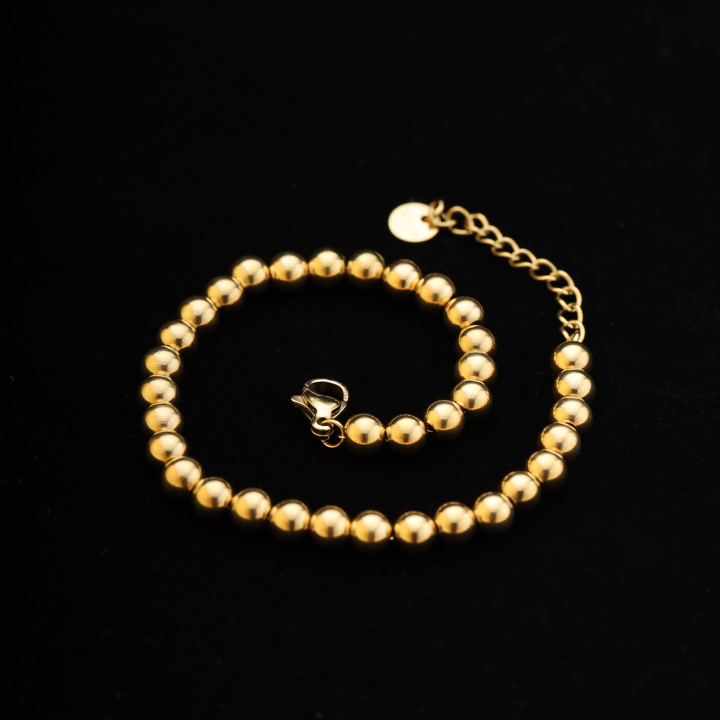 lat lay on black background showing entire 15cm + 5cm bracelet with lobster clasp