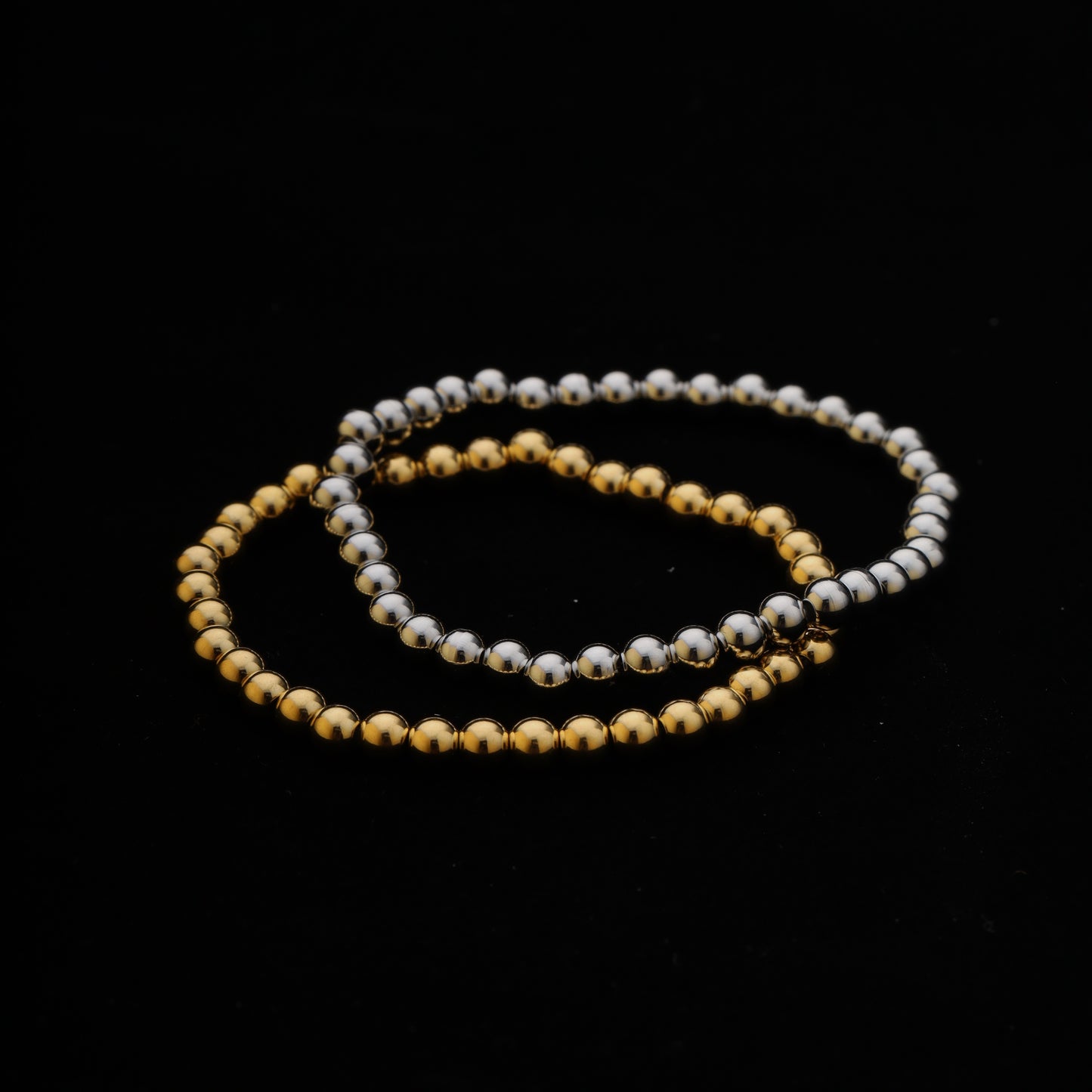 Minimalist photo of two stretchy beaded bracelets overlapping