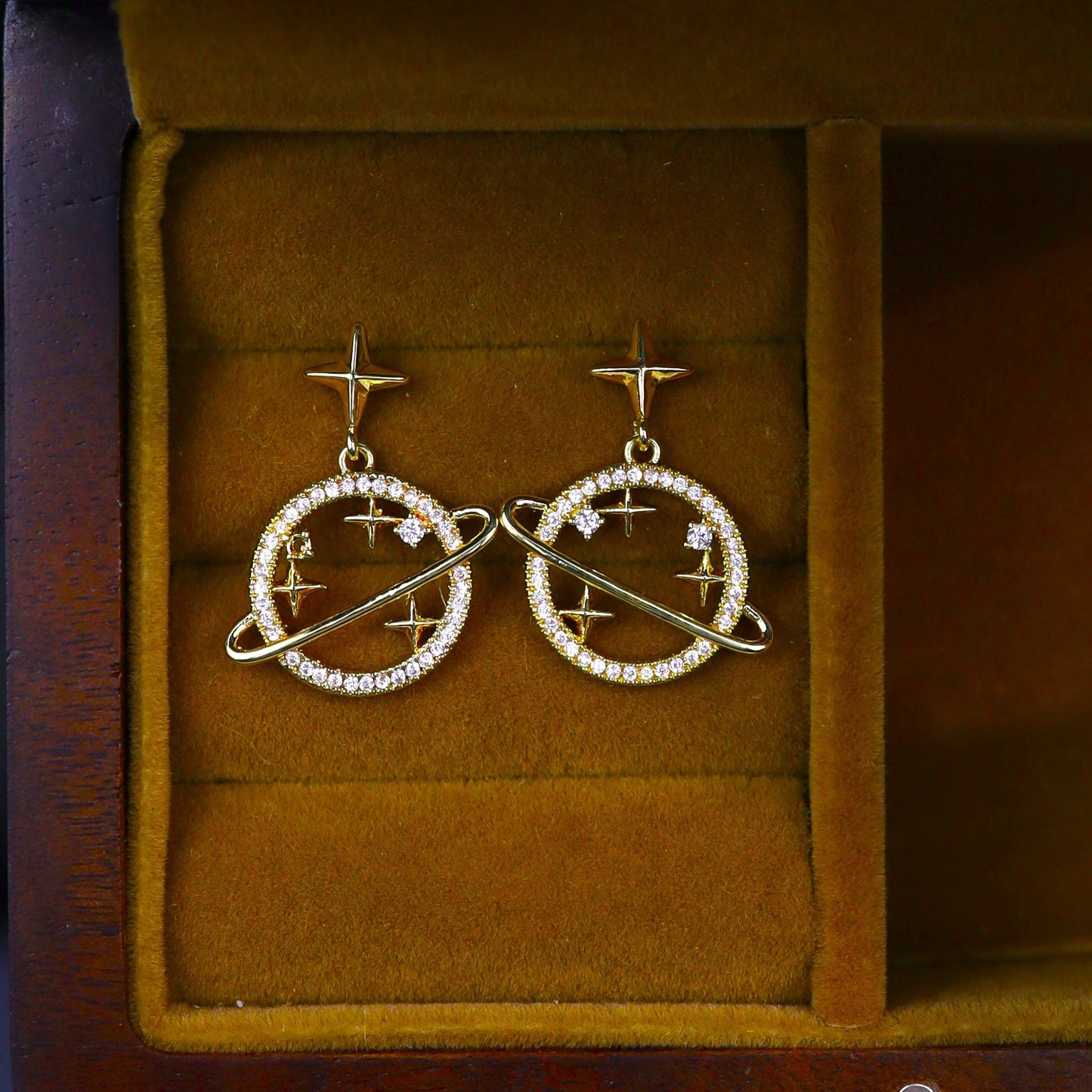 Celestial-inspired earrings featuring a planetary ring design
