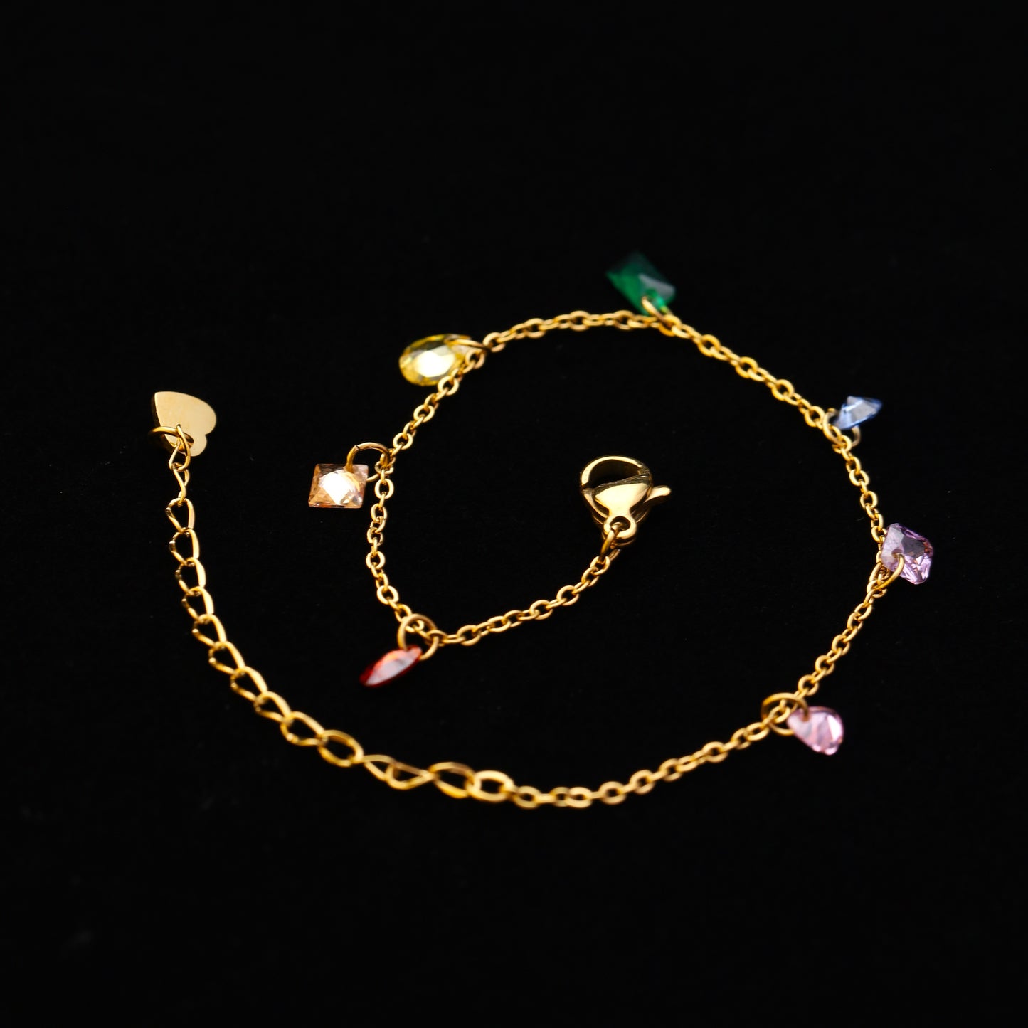 Dangling crystal bracelet draped over gold tray