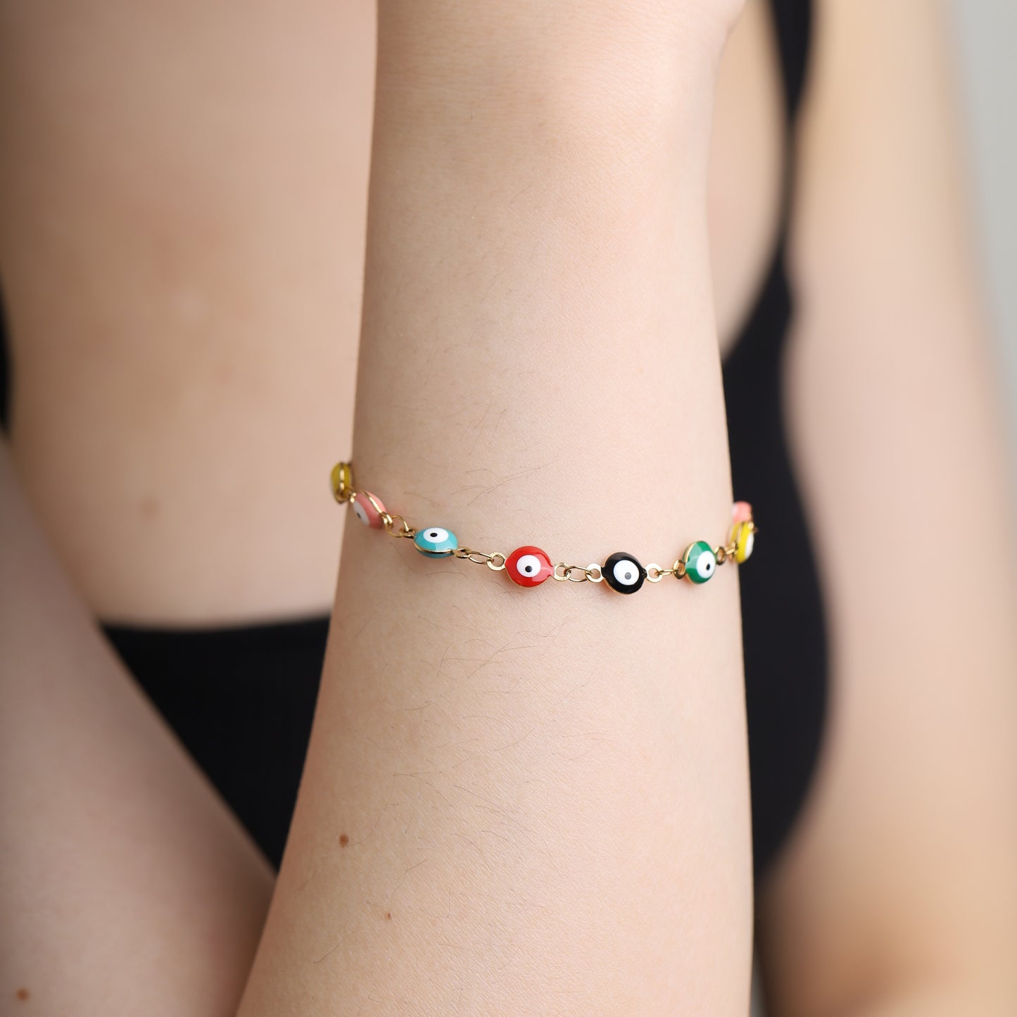 Multicolor evil eye enamel bracelet on wrist