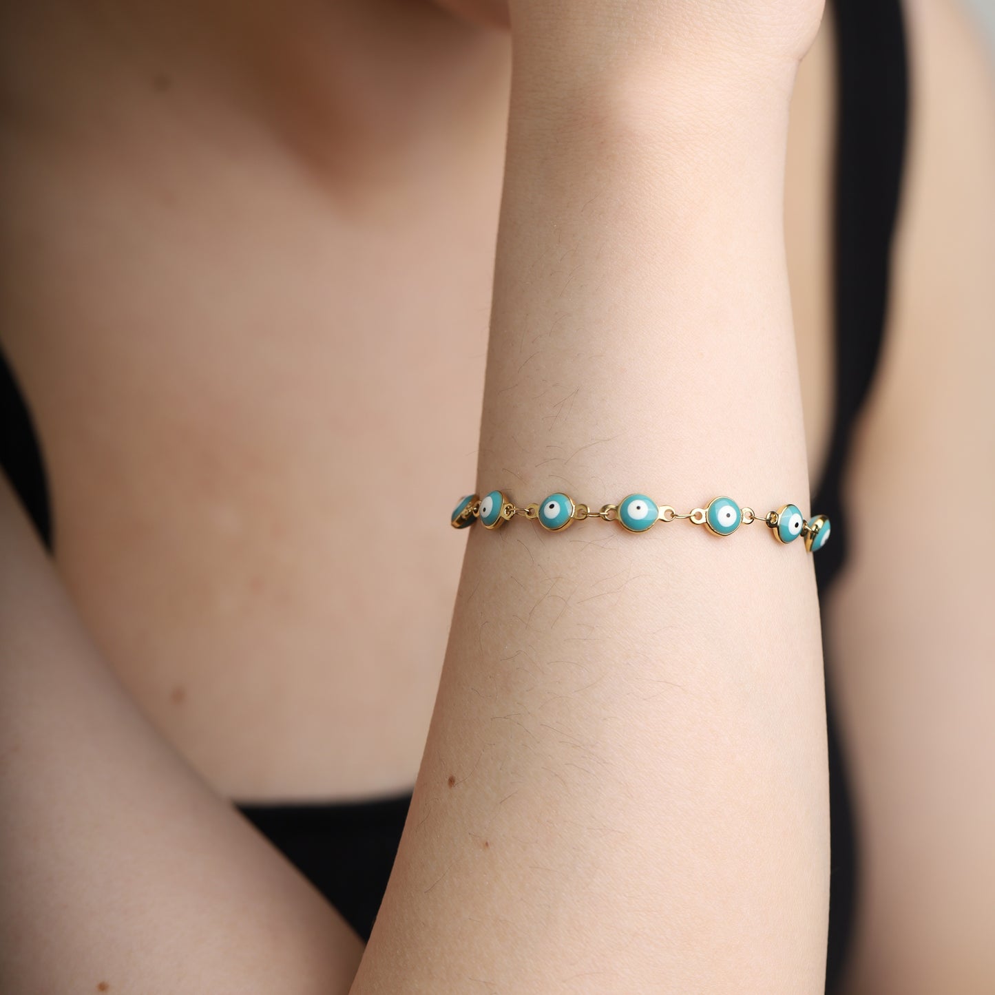 Turquoise evil eye bracelet styled on wrist