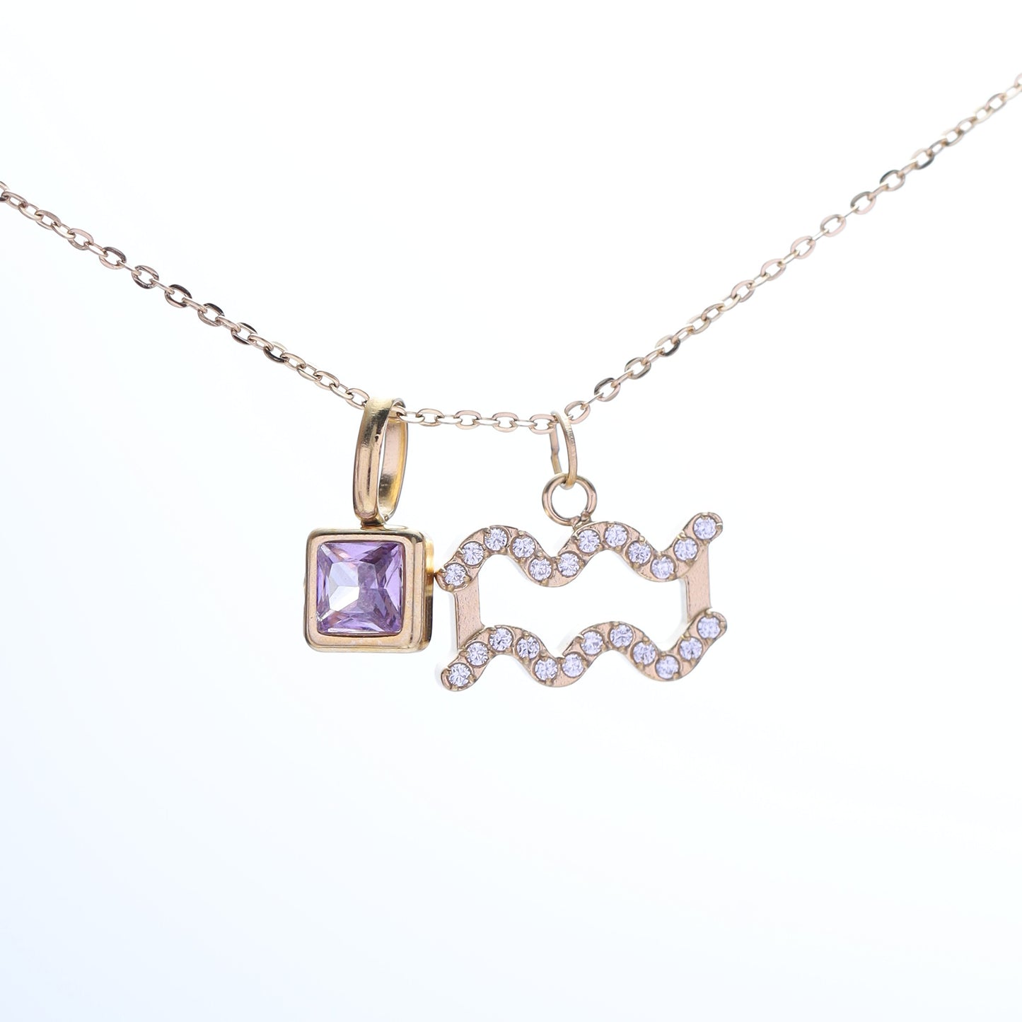 A close-up of the Aquarius zodiac necklace, highlighting the fine detailing and charm placement.