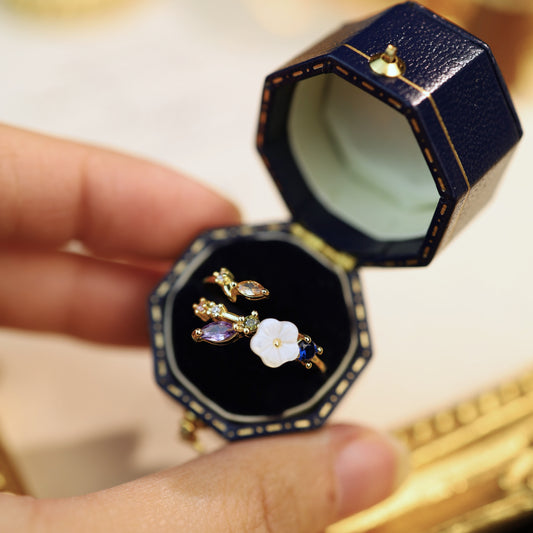 A gold-plated flower ring presented in a navy velvet jewelry box, perfect for gifting.
