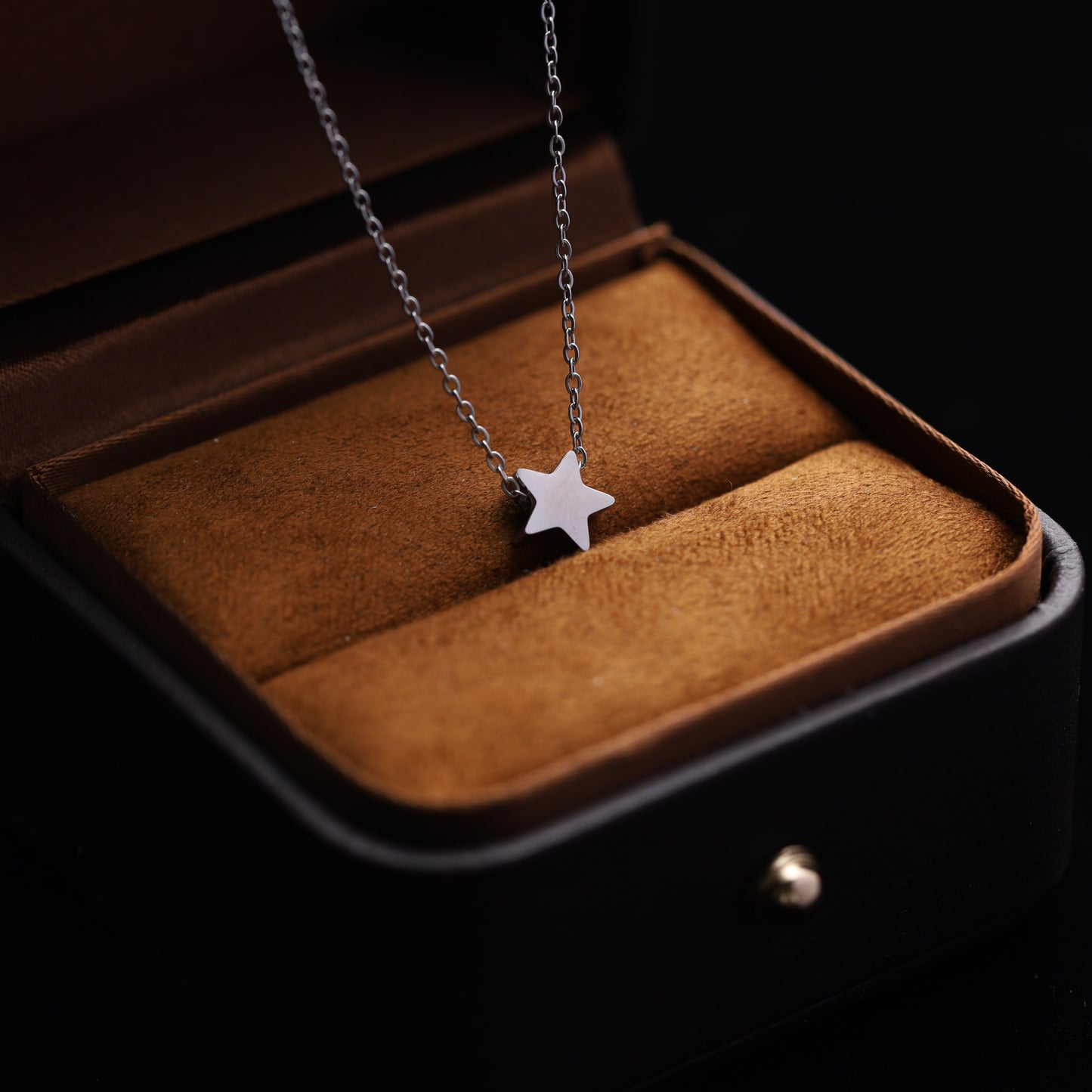 Silver stainless steel star necklace with a delicate celestial charm.
